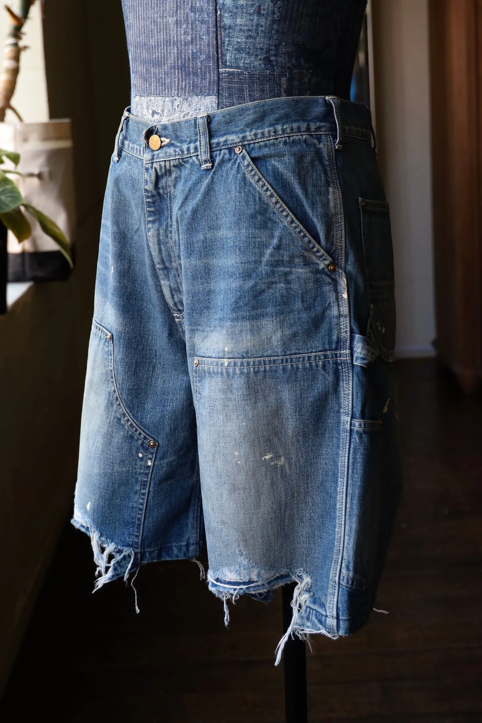 SAINT Mxxxxxx DOUBLE KNEE SHORTS/BLU Knee patches splashed with ink and water-splashed denim shorts. Denim blue S-XL. Custom-woven and dyed denim fabric with clear texture. Heavy-wash water-fading treatment to create local mottled fading/hole effects. Artificial distressing to simulate natural wearing marks. VINTAGE sense. Original consistent damage treatment. Hand-splashed ink and paint. Original consistent wash mark/pocket mark. Double knee patch. Rivet reinforcement. Improve functionality while enhancing design